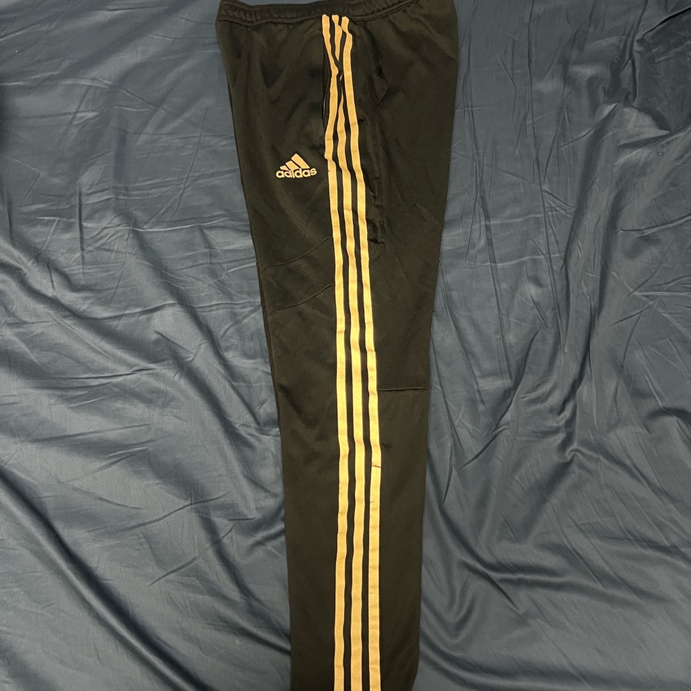 Adidas Black and Gold Sweatpants with Iconic Stripes
